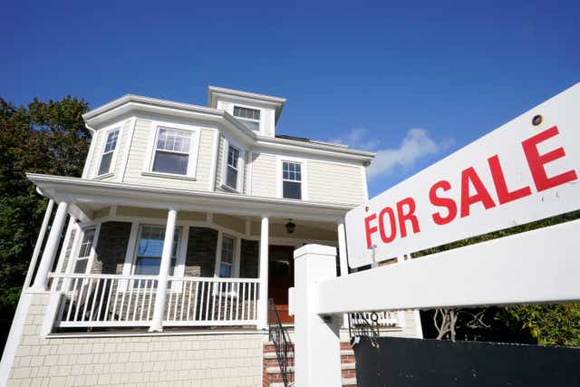 <p>A for sale sign stands in front of a house, on Oct. 6, 2020, in Westwood, Mass. </p>
