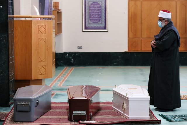 An imam prays over the coffins of 37-year-old Seema Banu, and her 11-year-old daughter Asfira Syed and six-year-old son Faizan Syed at the Islamic Cultural Centre in Dublin ahead of their burial in Newcastle cemetery in 2020 (Brian Lawless/PA)