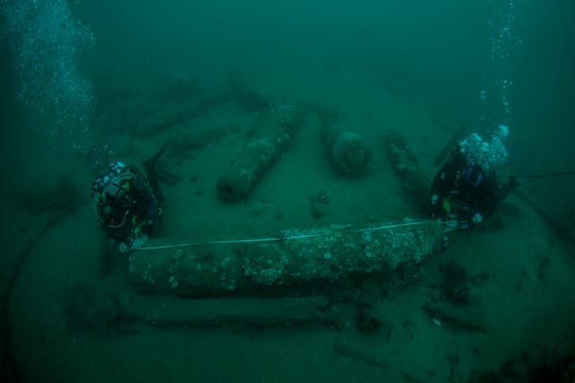 Brothers Julian and Lincoln Barnwell examine a cannon from the wreck of the HMS Gloucester, which they located off the Norfolk coast (Norfolk Historic Shipwrecks/ PA)