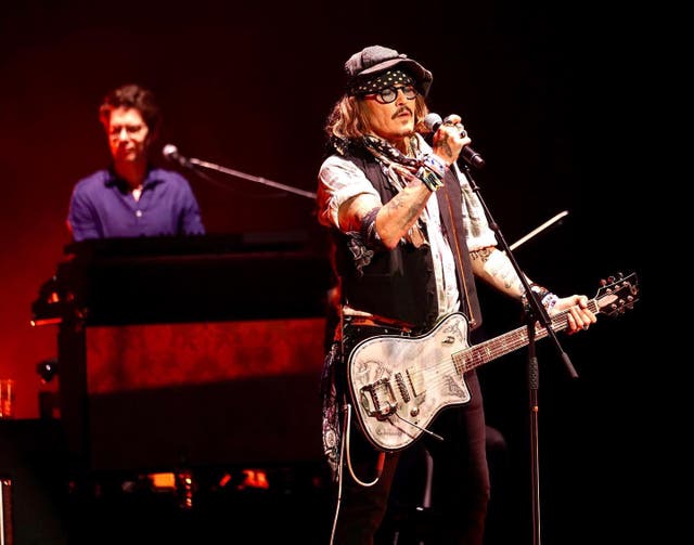 <p>Johnny Depp performing (Raph Pour-Hashemi/PA)</p>