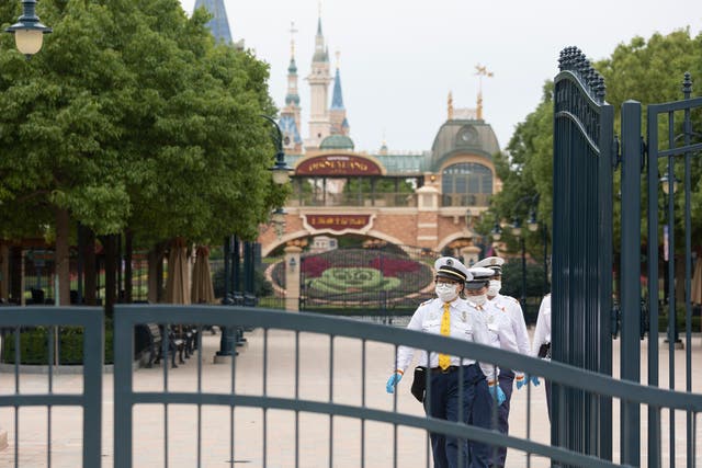 <p>Resort staff walk in the closed section of Disneyland at Shanghai Disney Resort on 10 June 2022 in Shanghai, China</p>