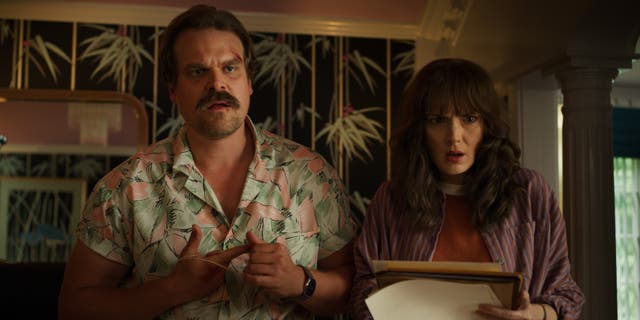 <p>David Harbour with co-star Winona Ryder in ‘Stranger Things’ (Netflix/PA)</p>