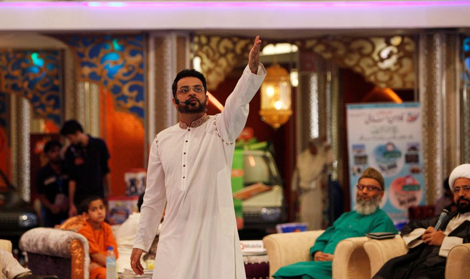 FILE: Aamir Liaquat Hussain, host of the Geo TV channel programme ‘Amaan Ramazan’, gestures during a live show in Karachi