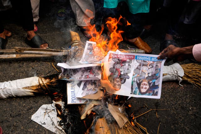 <p>Indian Muslims burn an effigy with portraits of Nupur Sharma, the spokesperson of governing Hindu nationalist party over her comments on Prophet Mohammed </p>