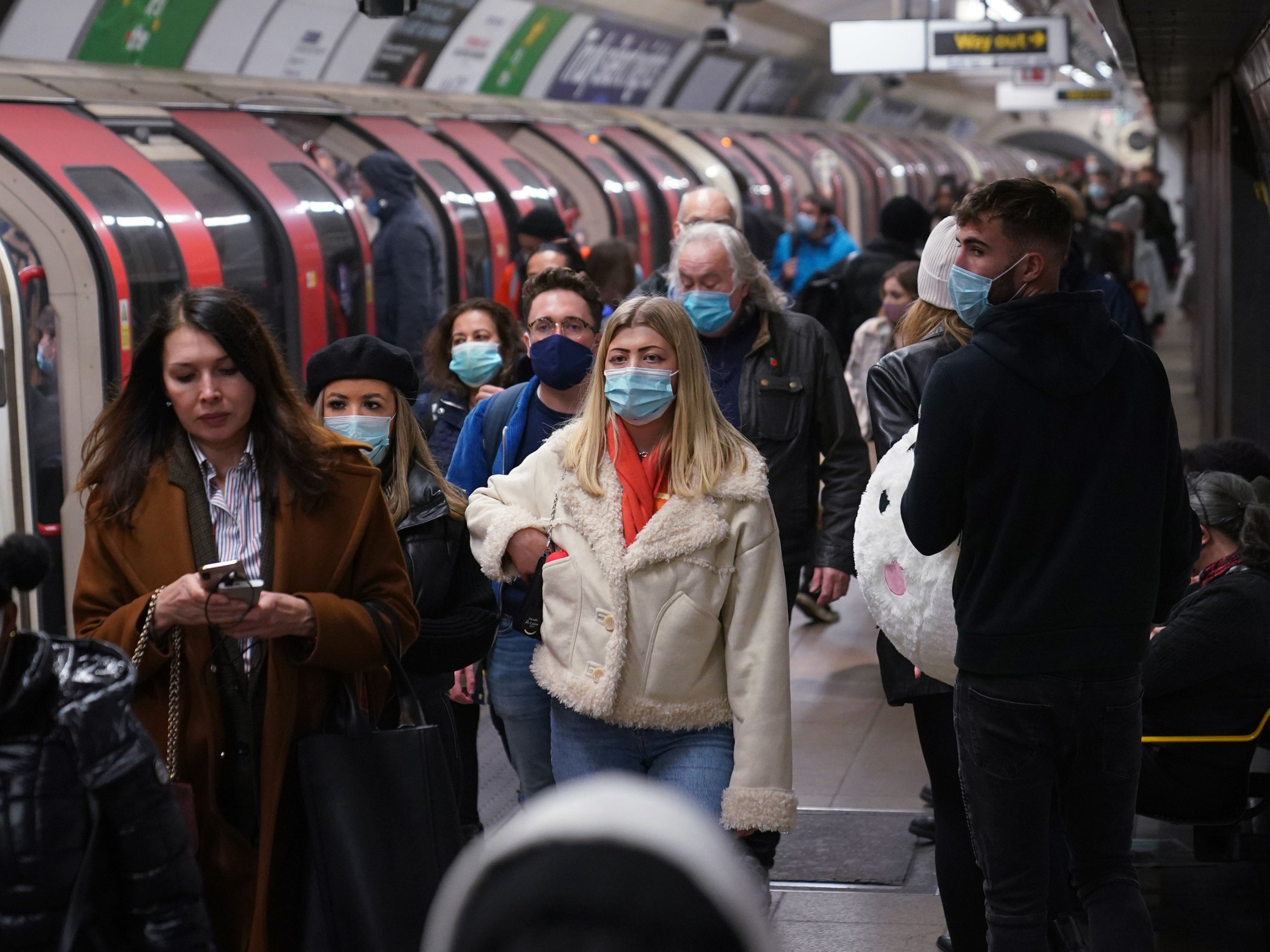 File photo: Commuters on the Tube network in London wear masks during a rise in Covid cases