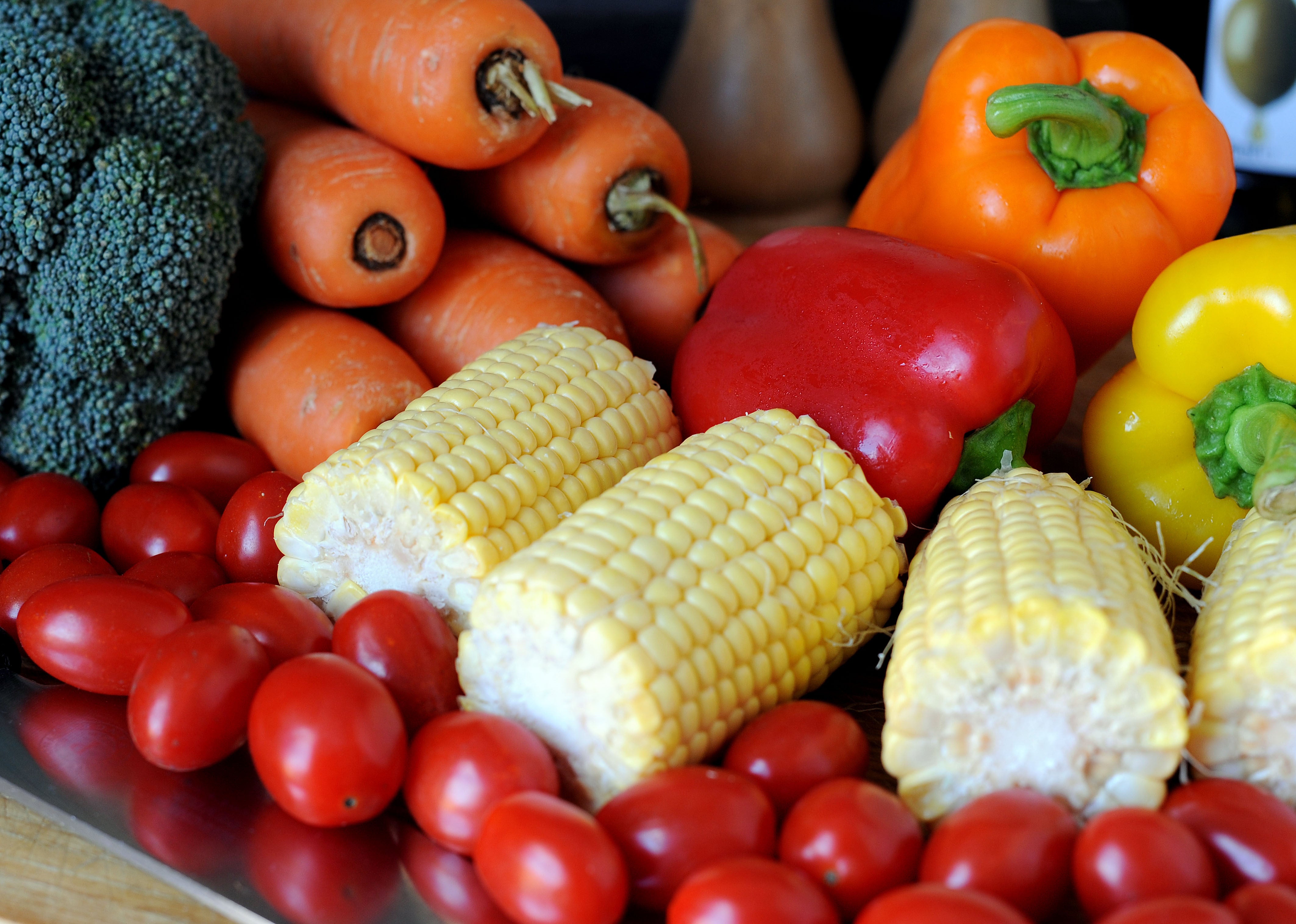 Vegetable stock photo of baby plum tomatoes, corn cobs, red, yellow and orange peppers, broccoli and carrots (Nick Ansell/PA)