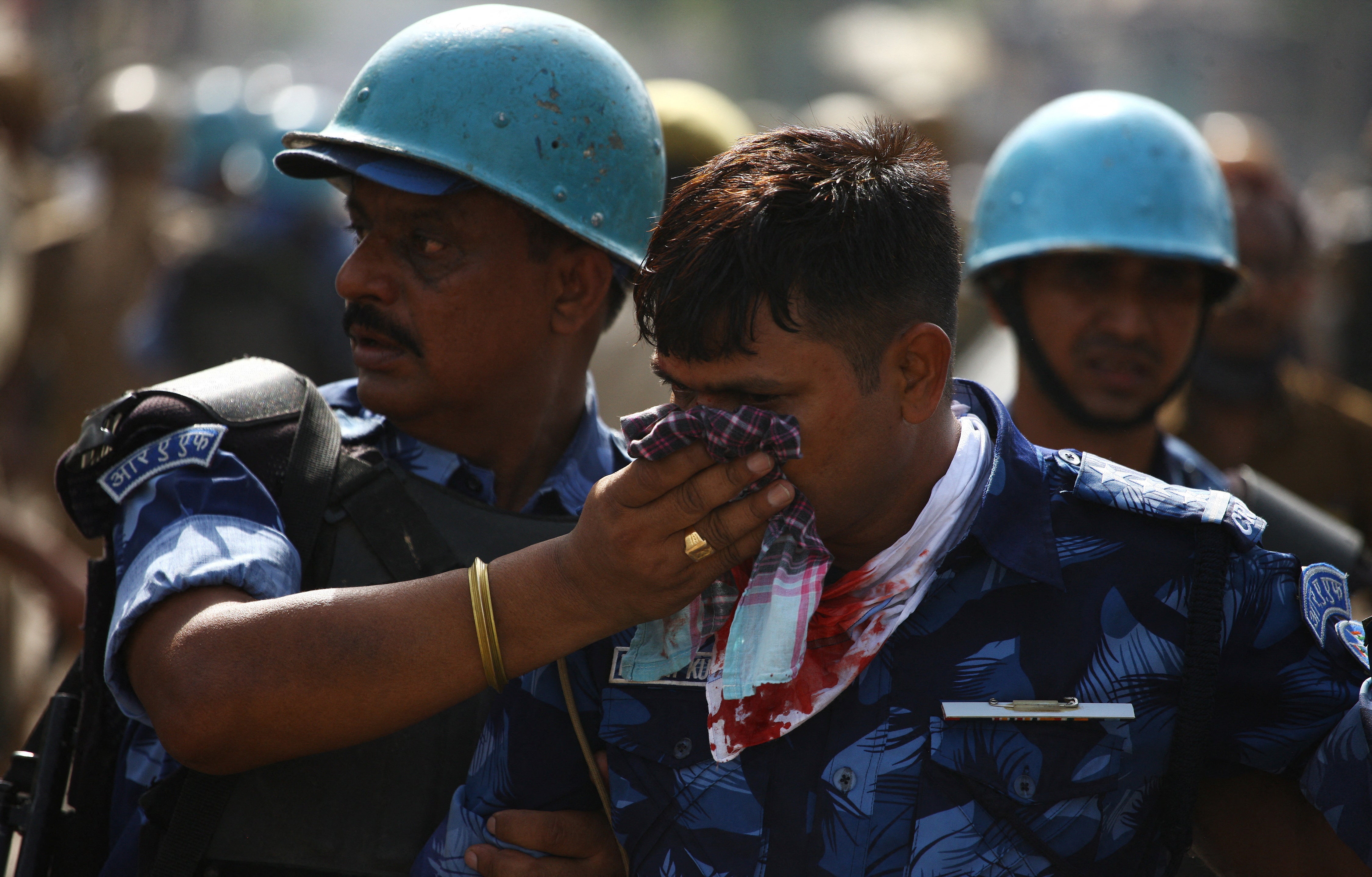 A policeman is being helped by his colleagues after he was injured during a protest against Nupur Sharma for her comments on Prophet Muhammad in India’s Prayagraj city