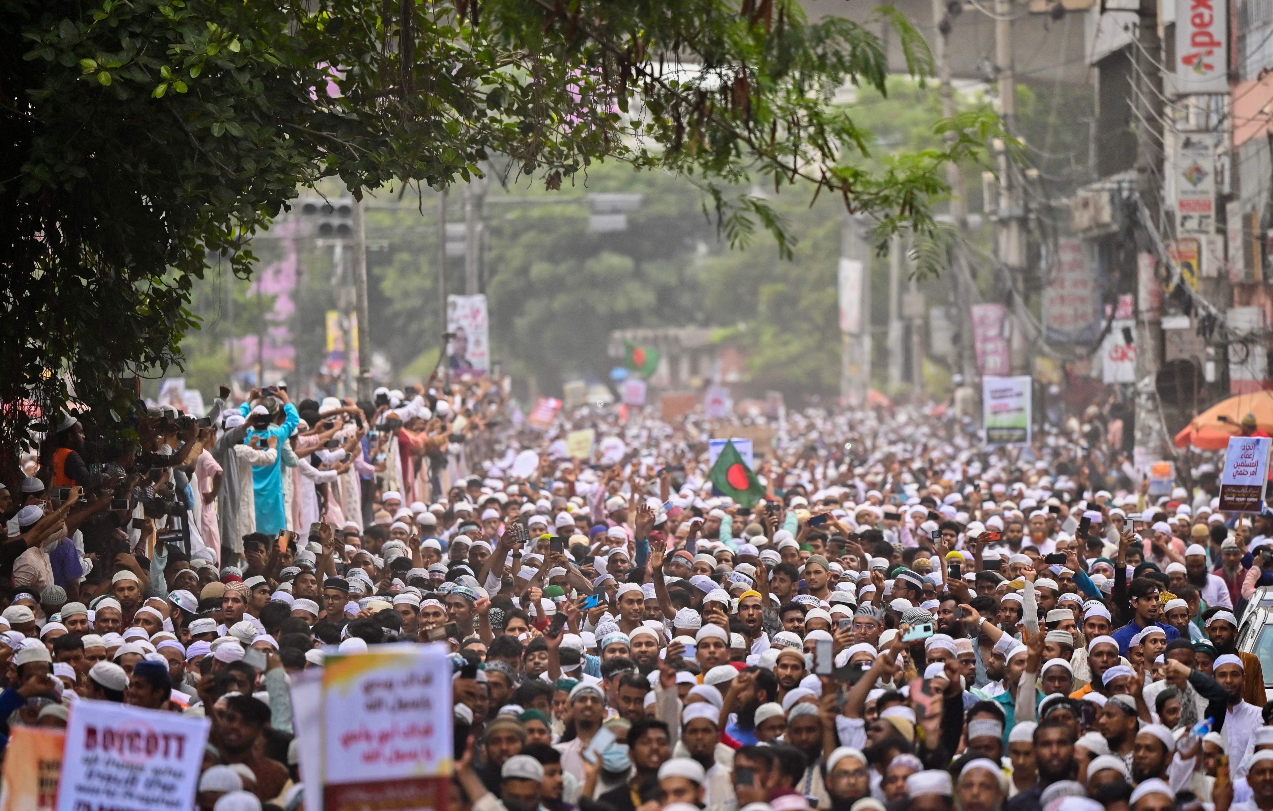 Bangladesh’s Islamist parties’ activists and supporters hold placards and shout anti-India slogans during a demonstration in Dhaka on 10 June to protest former BJP spokeswoman Nupur Sharma over her incendiary remarks about prophet Muhammad