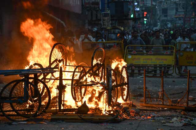 <p>Overturned handcarts are seen in flames following a protest against former India’s Bharatiya Janata Party spokeswoman Nupur Sharma and her remarks about Prophet Muhammad in Ranchi city on 10 June</p>