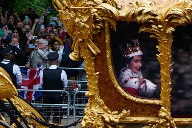 <p> Flanked by guardsmen on horseback to complete the illusion, the CGI Queen was glimpsed enthusiastically gesturing to the crowds </p>