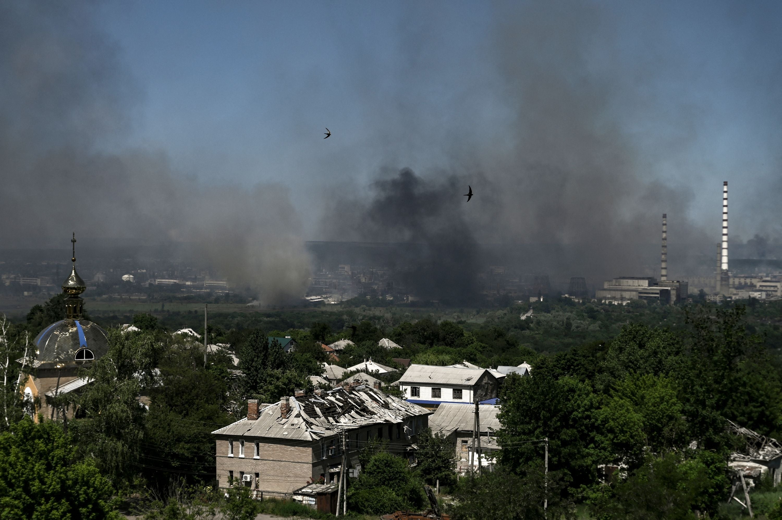 Black smoke and dirt rise from Sievierodonetsk during a battle between Russian and Ukrainian troops