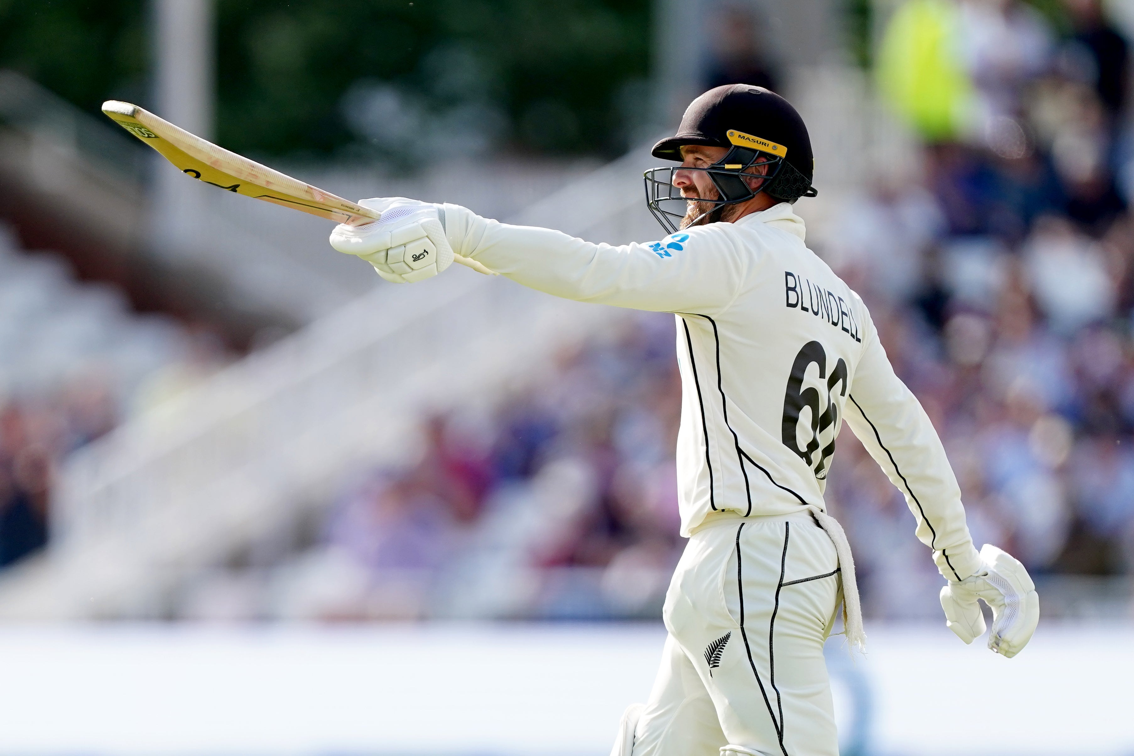 Tom Blundell raises his bat after reaching his century (Mike Egerton/PA).
