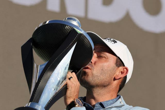 <p>Charles Schwartzel celebrates with the trophy</p>