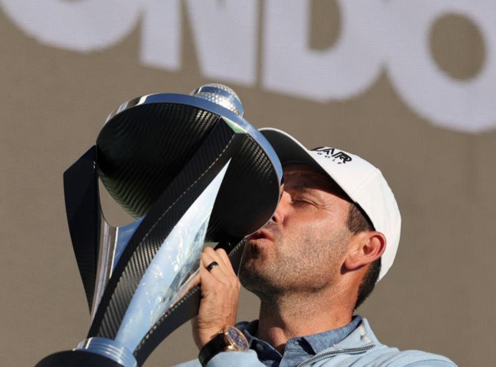 <p>Charles Schwartzel celebrates with the trophy</p>