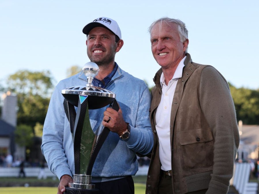 Charl Schwartzel and Greg Norman after the South African collected £3.85m for winning at Centurion