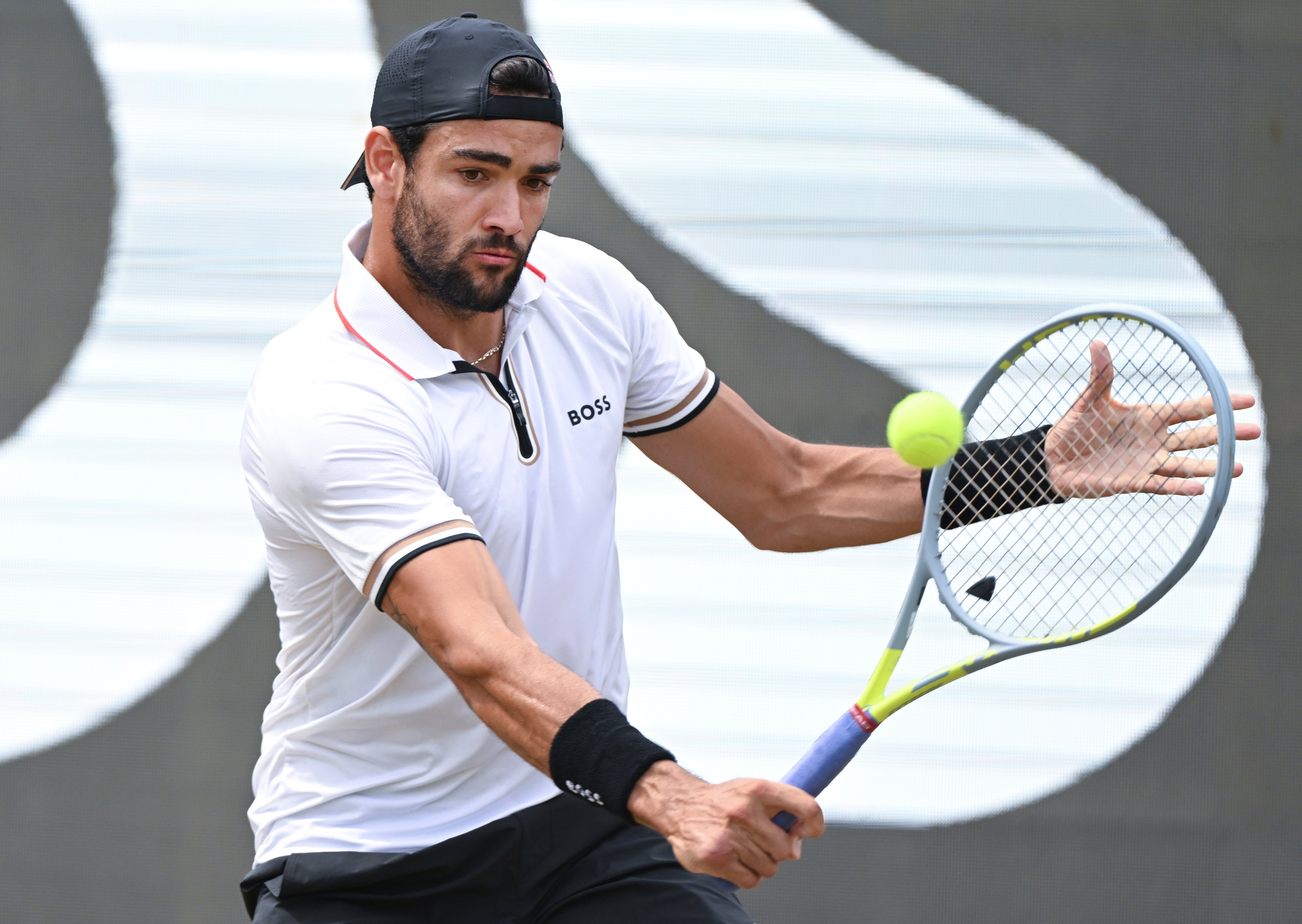 Matteo Berrettini plays a return to Britain's Andy Murray