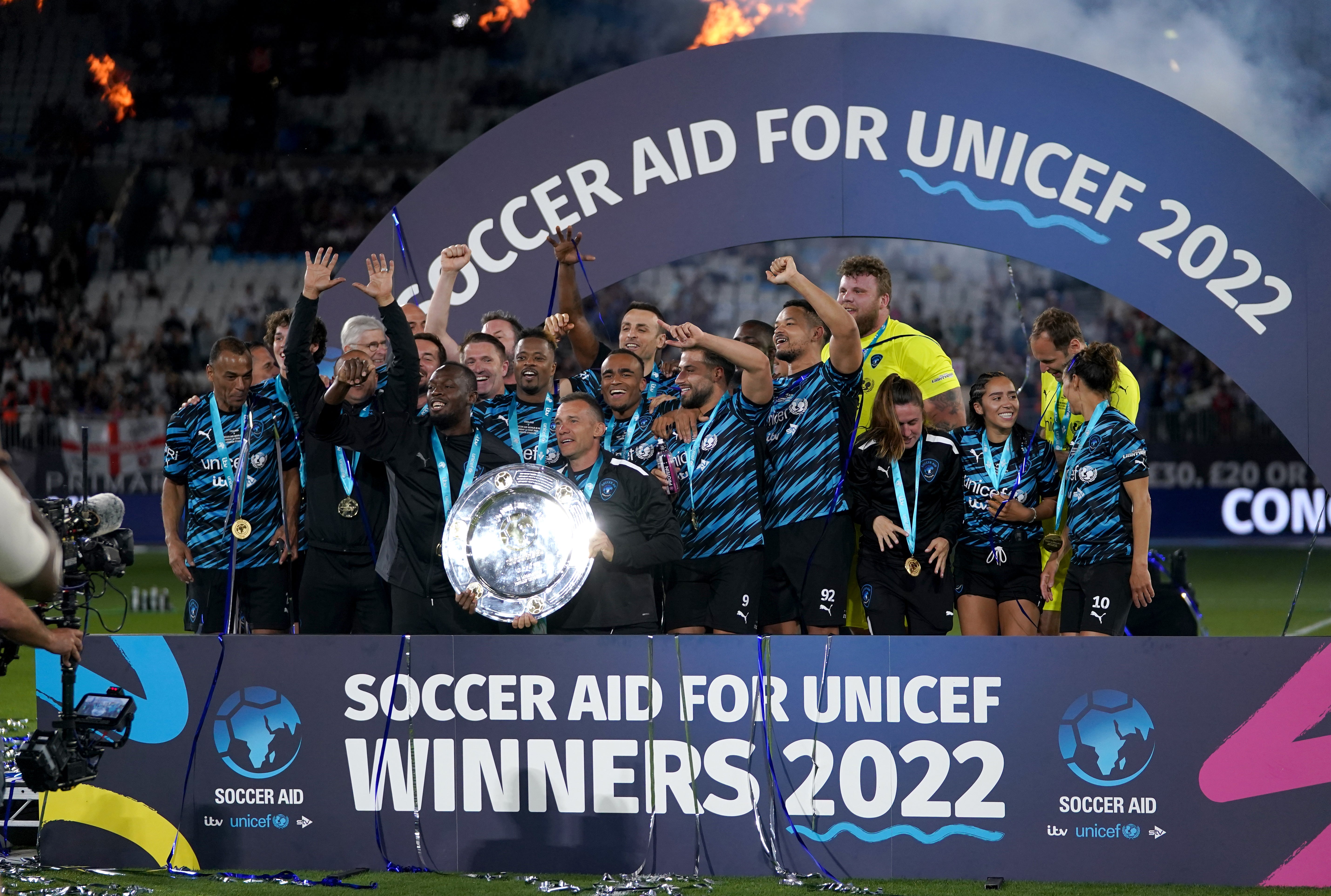 World XI players celebrate with the trophy (Zac Goodwin/PA)