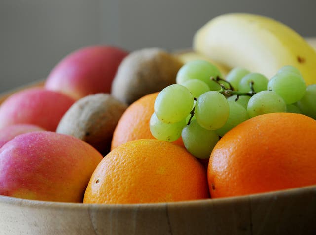 <p>Grapes, Oranges, apples bananas and Kiwifruit in a fruit bowl
</p>