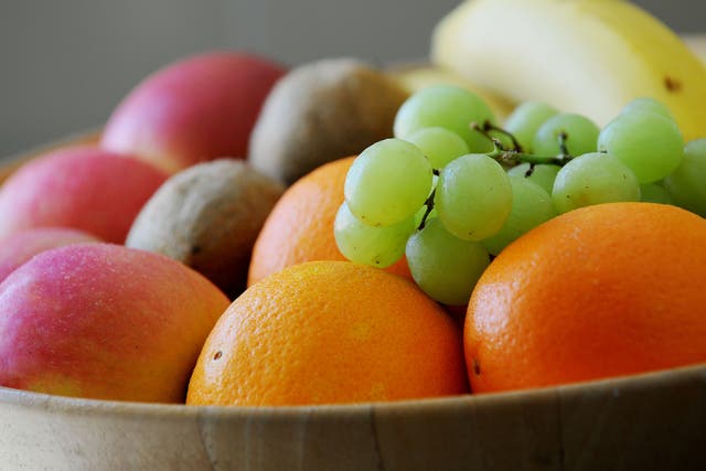 <p>Grapes, Oranges, apples bananas and Kiwifruit in a fruit bowl
</p>
