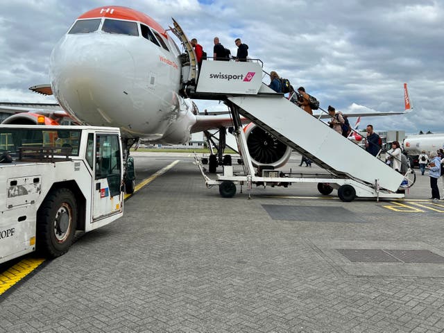 <p>Passengers boarding an easyJet Airbus A320 at Glasgow airport
</p>