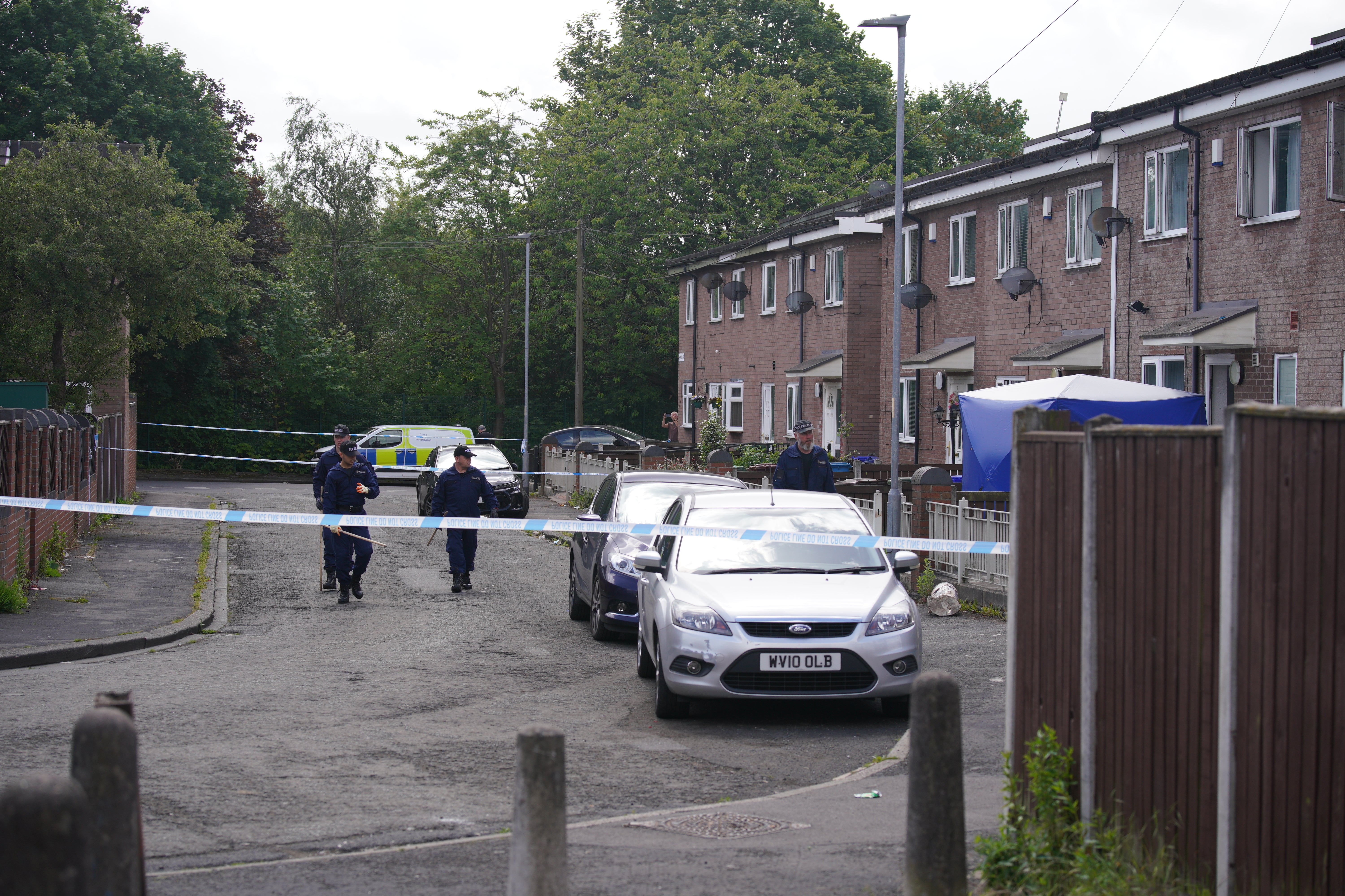 Police officers at the scene in Bednal Avenue, Miles Platting, Manchester, following the incident (Peter Byrne/PA)