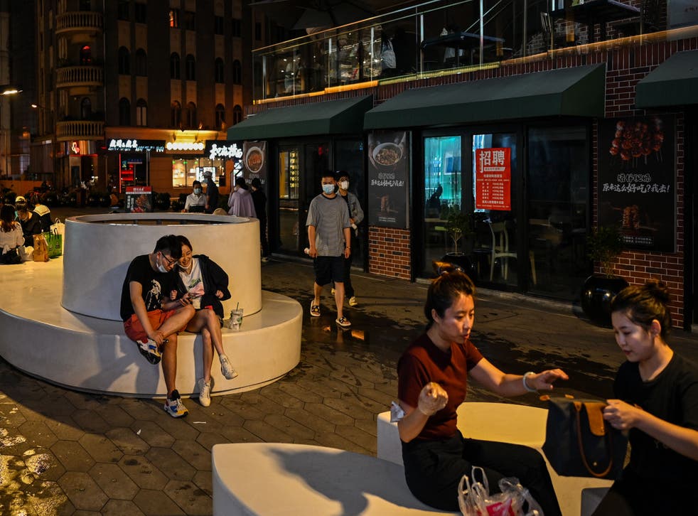 <p>People are seen on a pedestrian street in the Jing’ an district of Shanghai </p>