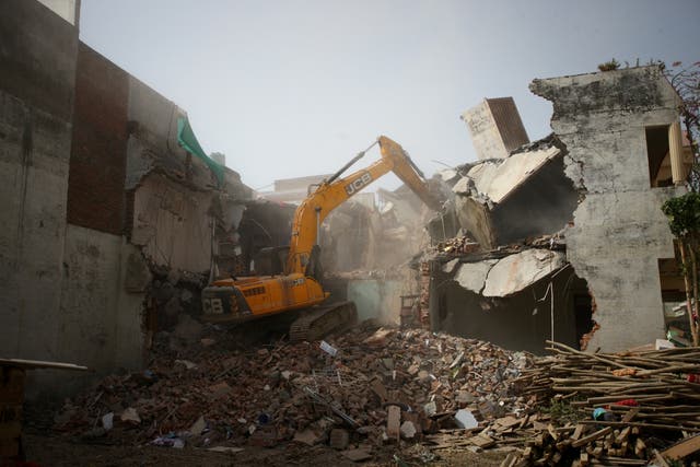 <p>A bulldozer demolishes the house of a Muslim man in Prayagraj on 12 June</p>