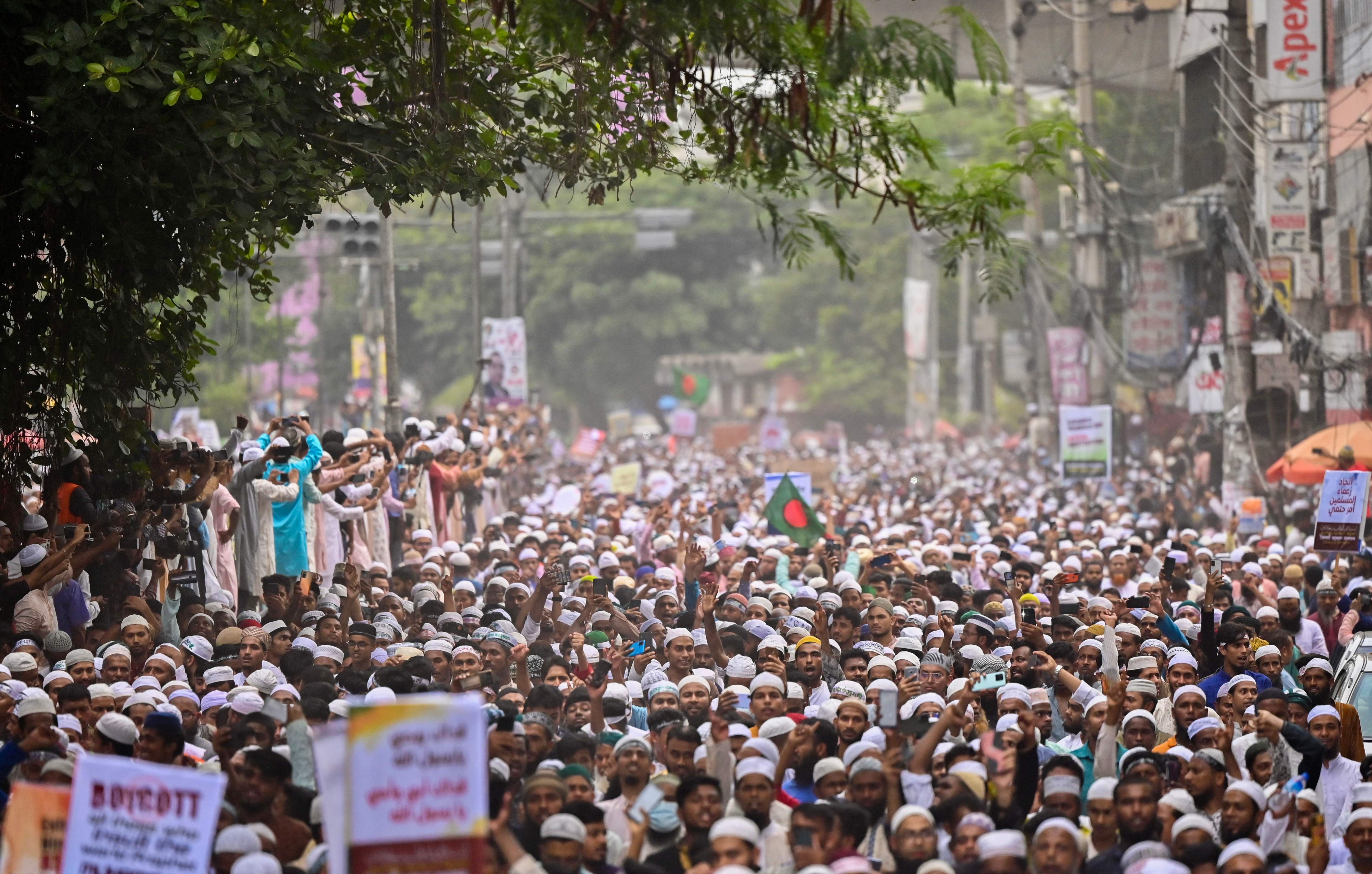 Bangladesh's Islamist parties' activists and supporters hold placards as they shout anti-India slogans during a demonstration in Dhaka on 10 June 2022, to protest against former India's Bharatiya Janata Party spokeswoman Nupur Sharma over her incendiary remarks about Prophet Mohammed