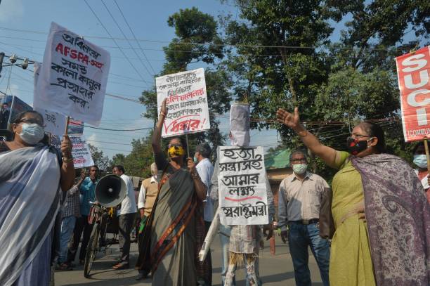 Supporters of Socialist Unity Centre of India (SUCI) shout anti government slogans and carry an effigy of India's home minister Amit Shah as they protest the killing of 14 civilians