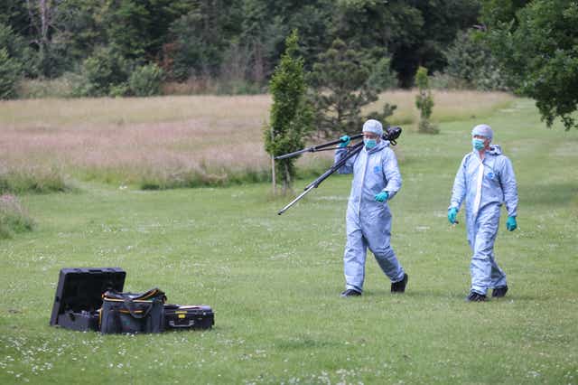 Officers in forensic suits in Belvue Park, Northolt, west London, on Monday. (James Manning/PA)