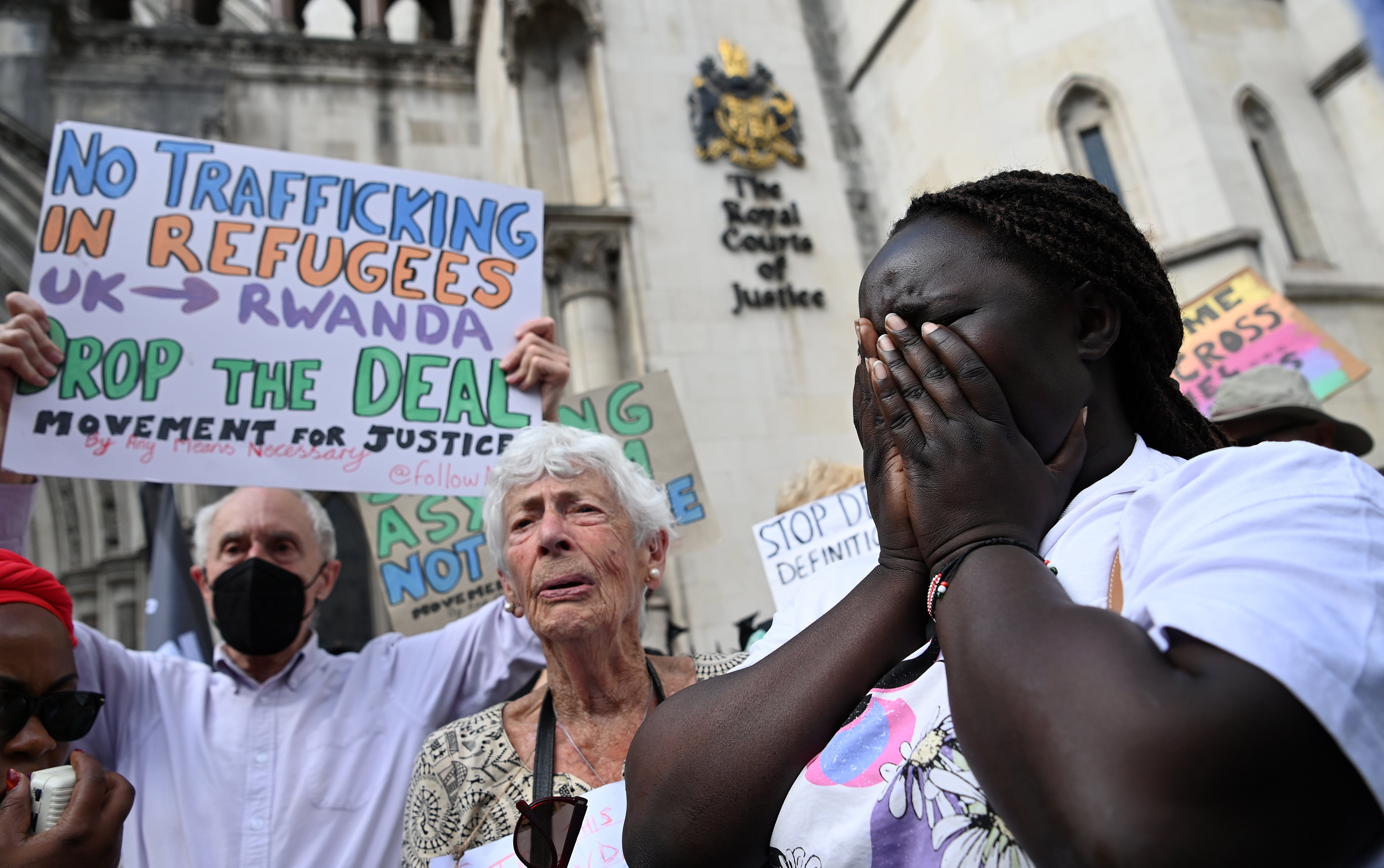 Human rights campaigners react after losing the appeal outside the High Court in London on Monday