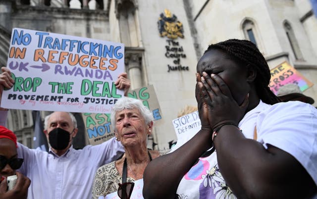 <p>Human rights campaigners react after losing the appeal outside the High Court in London on Monday</p>