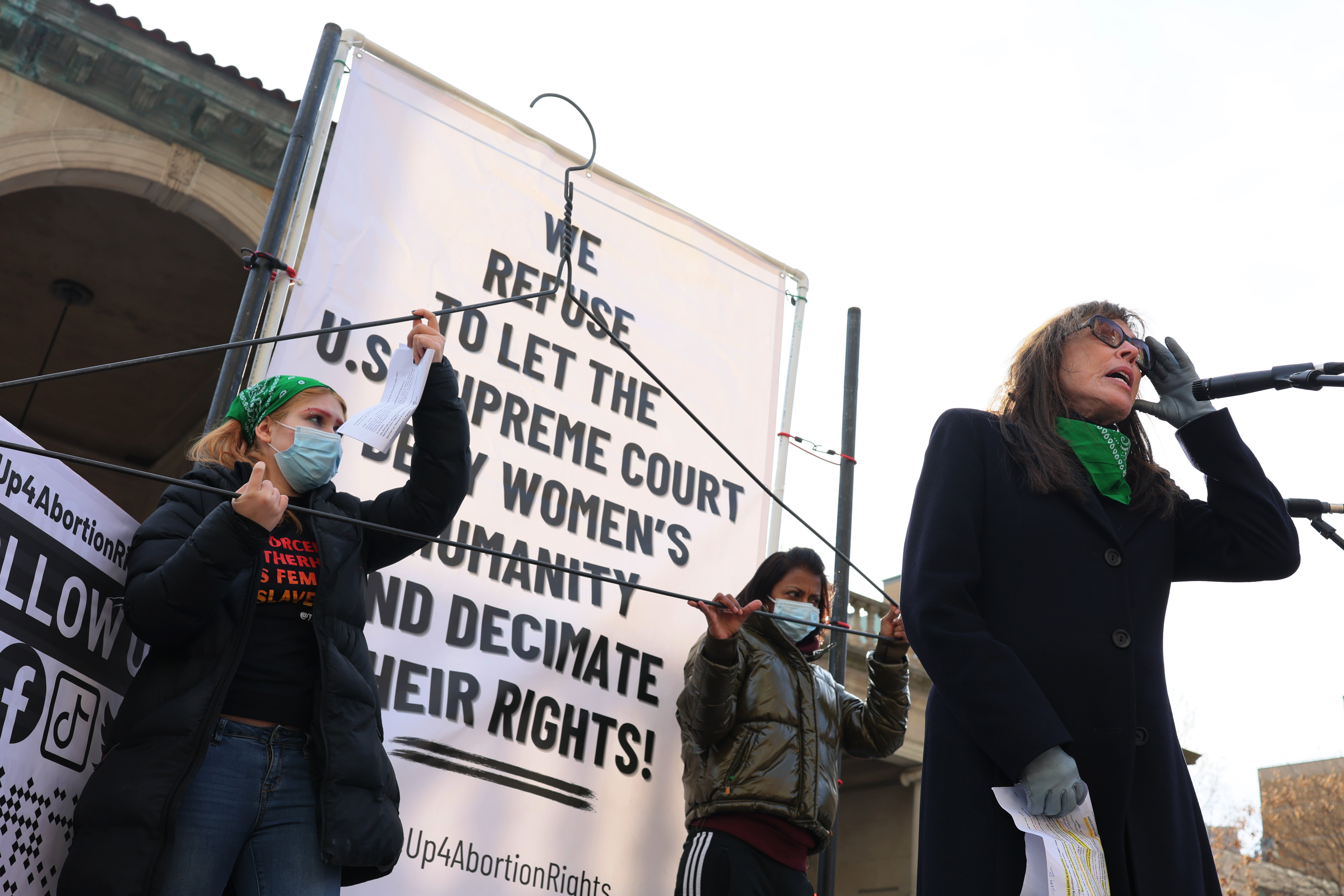 Merle Hoffman, right, speaks at a rally in New York City on 8 March, 2022.