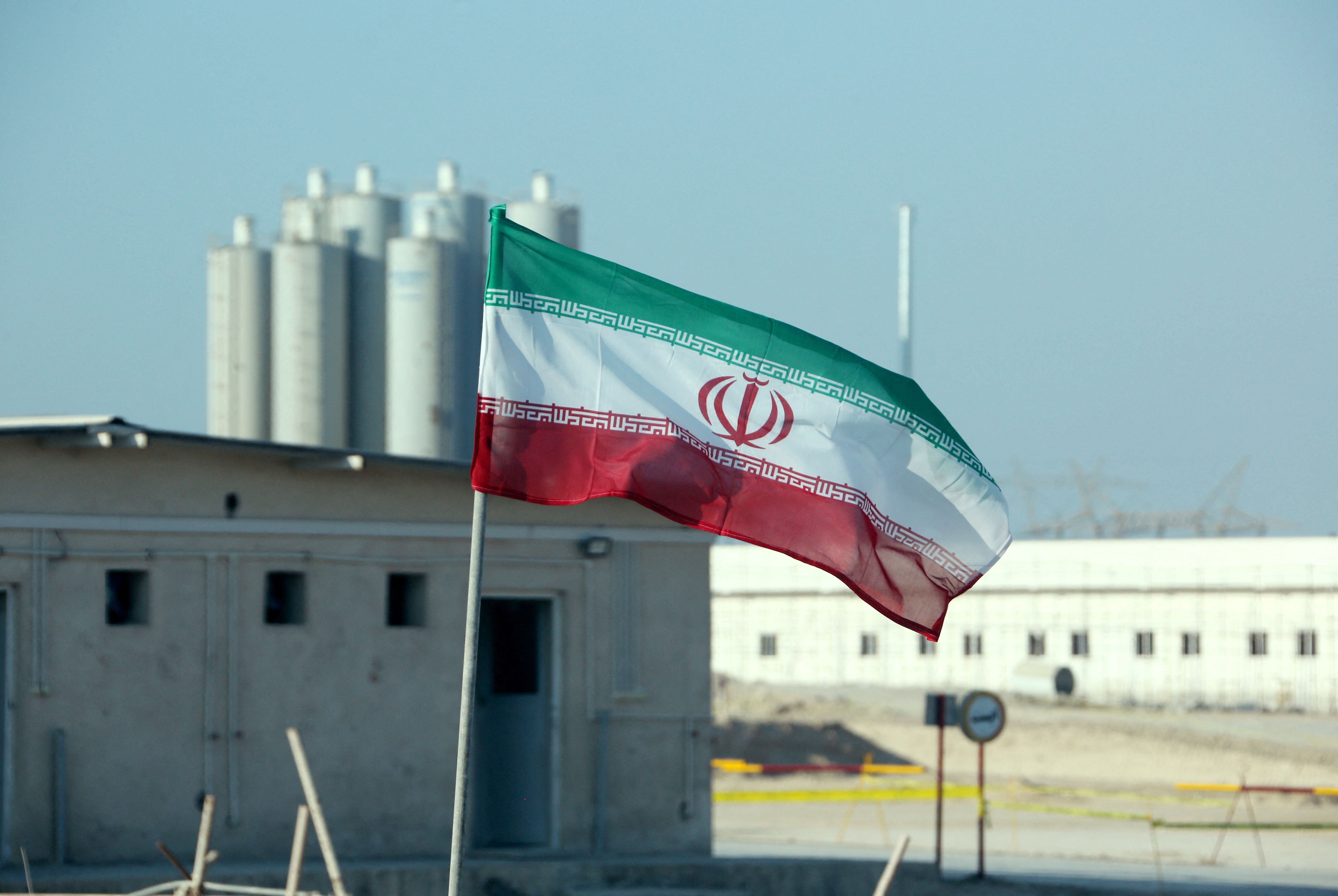 <p>The Iranian flag flutters in front of Bushehr nuclear power plant </p>