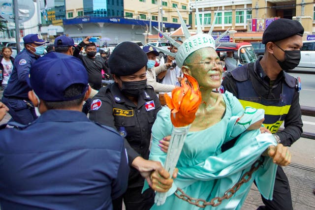 <p>Cambodian-US human rights advocate Theary Seng, dressed as Lady Liberty, is arrested by police after being found guilty of treason in her trial in front of the Phnom Penh municipal court on 14 June 2022</p>