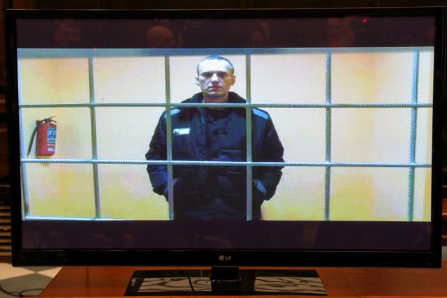 <p>Navalny is seen on a screen via a video link from his previous prison camp, the Correctional Colony No. 2</p>