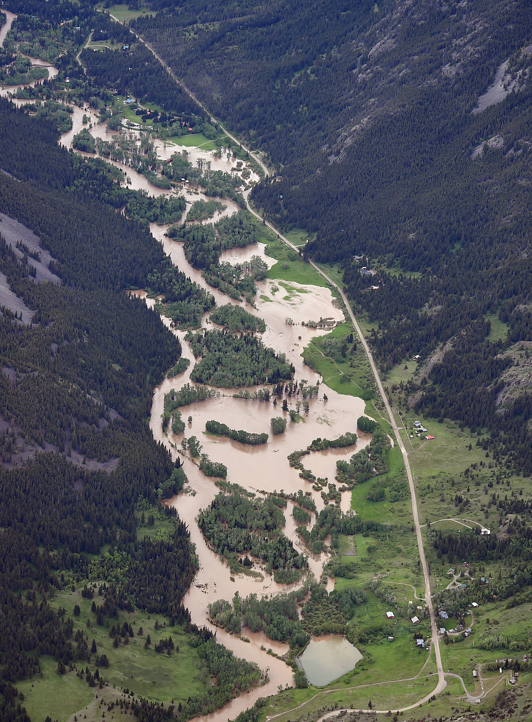 The Boulder River south of Big Timber floods roads and homes on Monday, June 13, 2022, as major flooding swept away at least one bridge, washed away roads and set off mudslides in Yellowstone National Park in Montana