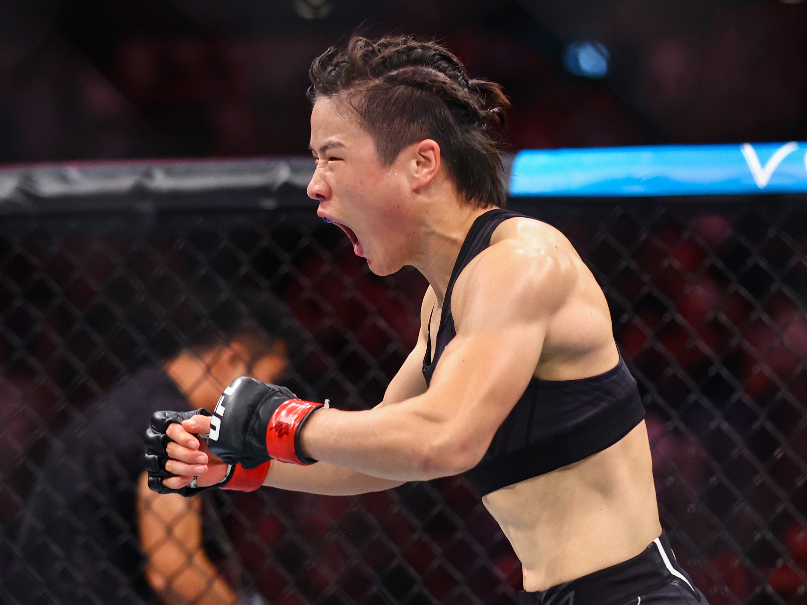 Weili Zhang celebrates her spinning back fist knockout of Joanna Jedrzejczyk
