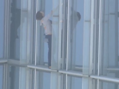 Maison Des Champs, who calls himself the ‘pro-life Spiderman’ clings to the side of the Devon Tower in Oklahoma City, during a stunt climb to protest women’s abortion rights.