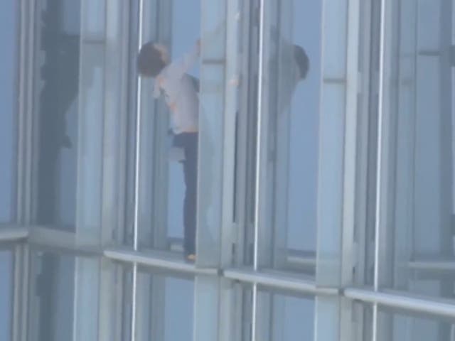 <p>Maison Des Champs, who calls himself the ‘pro-life Spiderman’ clings to the side of the Devon Tower in Oklahoma City, during a stunt climb to protest women’s abortion rights. </p>