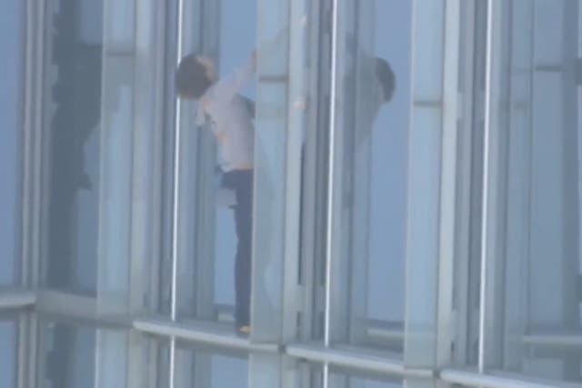 <p>Maison Des Champs, who calls himself the ‘pro-life Spiderman’ clings to the side of the Devon Tower in Oklahoma City, during a stunt climb to protest women’s abortion rights. </p>