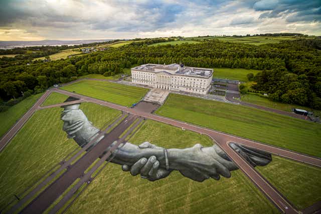 A giant biodegradable land art painting by French-Swiss artist Saype in the grounds of Stormont (Saype)