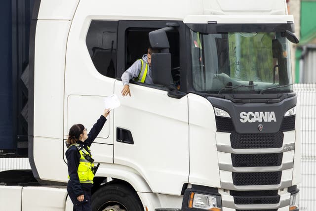 A Border Force Officer returns papers to a haulage driver after checks at the Department of Agriculture, Environment and Rural Affairs (DAERA), Northern Ireland Point of Entry (POE) Belfast Port site. Picture date: Tuesday May 17, 2022.