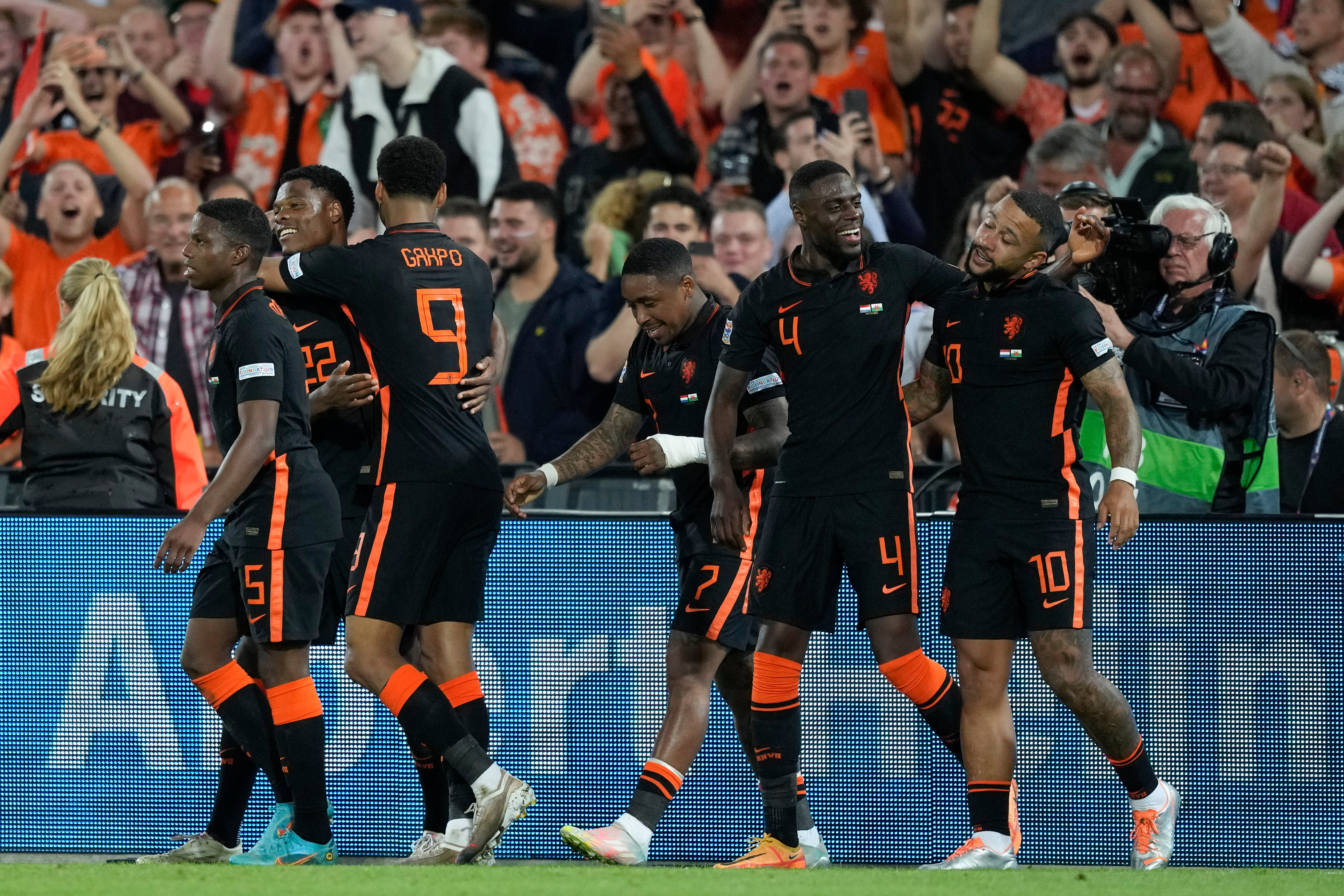Memphis Depay, right, celebrates his late Nations League winner against Wales in Rotterdam (Peter Dejong/AP)