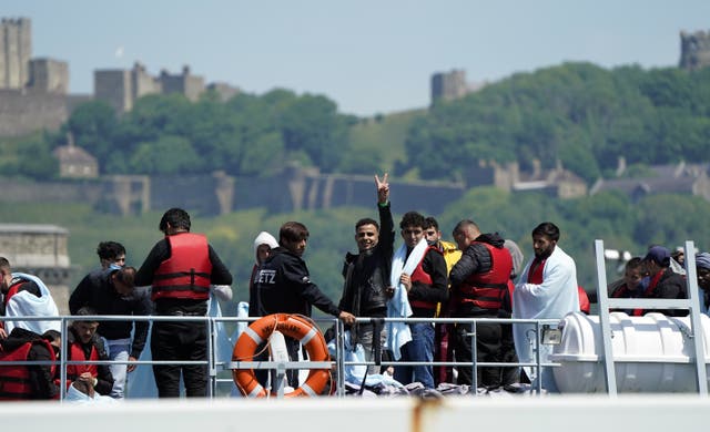 A group of people thought to be migrants are brought in to Dover (PA)