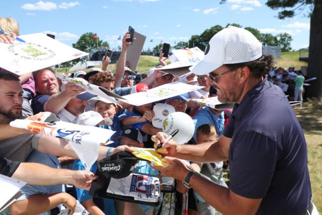 <p>Phil Mickelson signs autographs during a practice round at the US Open</p>