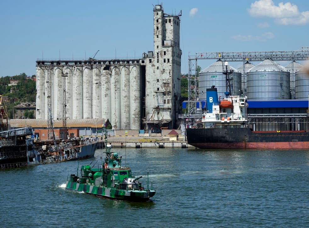 A Russian military boat guards an area of grain storage at the Mariupol Sea Port in Ukraine (AP)
