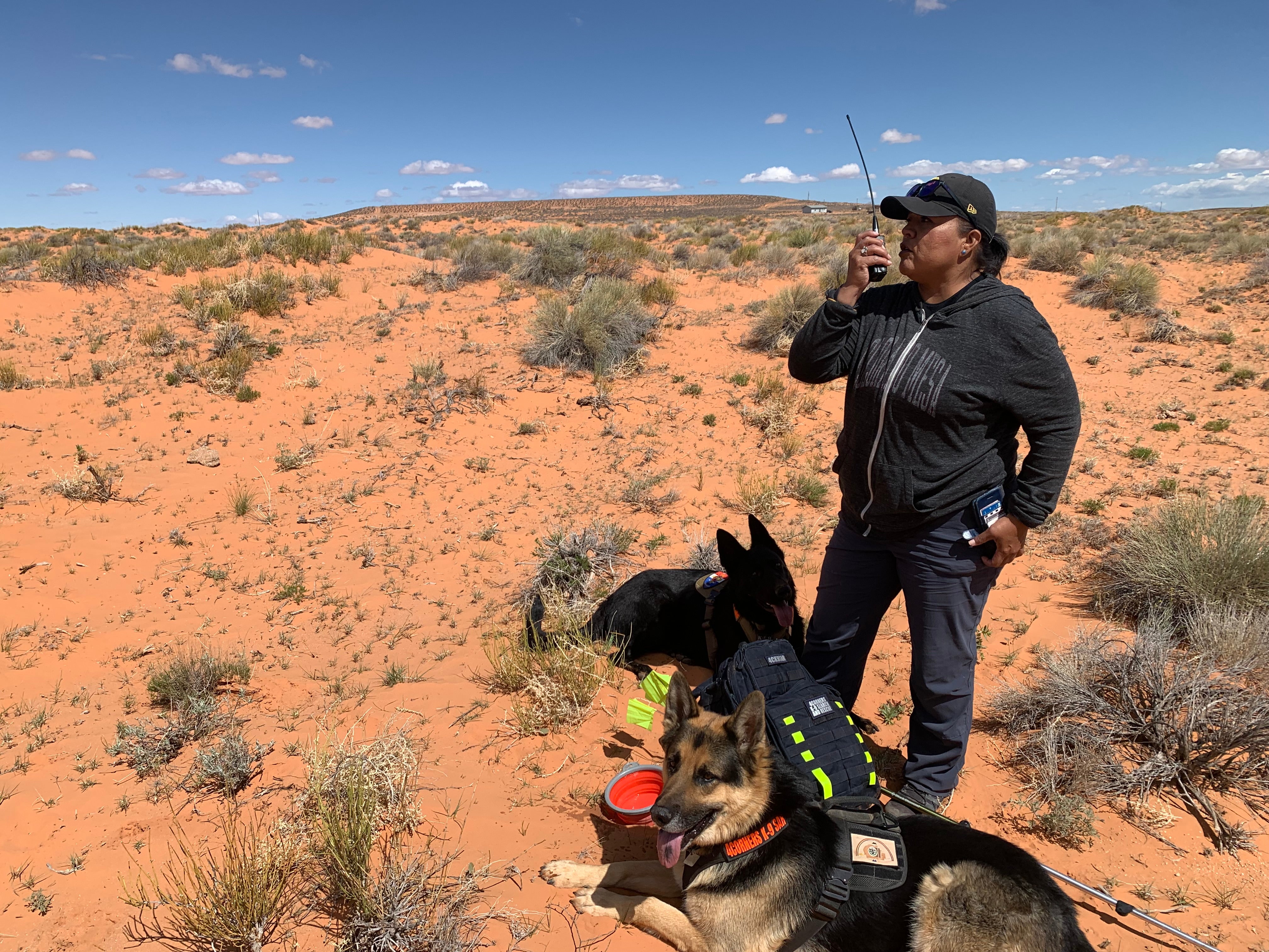 Bernadine Beyale, founder of Four Corners K9 Search and Rescue, and her two dogs, Trigger and Gunny, are seen during a search for a missing person on the Navajo Nation on April 23rd, 2022.