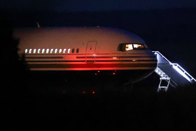 <p>The Rwanda flight on the tarmac at Boscombe Down air base on Tuesday evening </p>