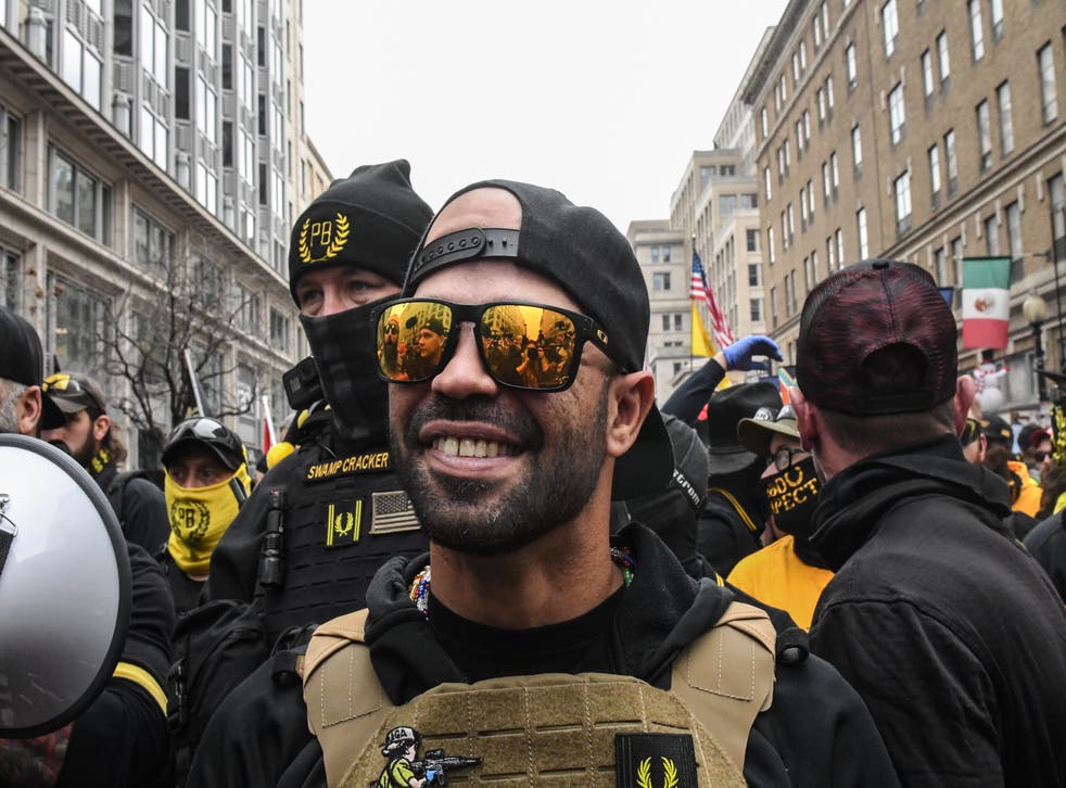 <p>Enrique Tarrio, former leader of the Proud Boys, stands outside Harry's bar during a protest on December 12, 2020 in Washington, DC, wearing Oakley sunglasses</p>